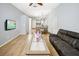 Spacious living room, hardwood floors, and view into kitchen area at 5301 Watson Rd, Riverview, FL 33578
