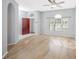 Living room with hardwood floors and a red front door at 5301 Watson Rd, Riverview, FL 33578