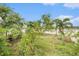 Landscaped backyard with mature trees and water view at 534 19Th Nw St, Ruskin, FL 33570