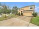 Two-story house with a tan exterior, two-car garage, and landscaping at 534 19Th Nw St, Ruskin, FL 33570