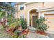 House entrance with landscaping and a two-car garage at 534 19Th Nw St, Ruskin, FL 33570