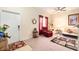 Living room with a red recliner, sofa bed, and cat tree at 534 19Th Nw St, Ruskin, FL 33570