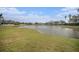 Peaceful pond view with lush green grass and neighborhood homes at 534 19Th Nw St, Ruskin, FL 33570