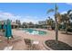 Community pool with lounge chairs, umbrellas, and a shaded seating area at 534 19Th Nw St, Ruskin, FL 33570
