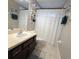 Clean bathroom with shower/tub combo, vanity, and tile floor at 558 Harbor Ridge Dr, Palm Harbor, FL 34683