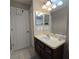 Bathroom with a vanity, tiled floors, and a view of the tub and shower at 558 Harbor Ridge Dr, Palm Harbor, FL 34683