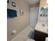 Clean bathroom with teal towel, artwork, and a vanity at 558 Harbor Ridge Dr, Palm Harbor, FL 34683