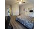 Main bedroom with wood-look floors, large bed and access to another room at 558 Harbor Ridge Dr, Palm Harbor, FL 34683