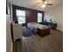 Spacious bedroom with dark wood floors, a bed, and a home office at 558 Harbor Ridge Dr, Palm Harbor, FL 34683