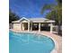 Inviting community pool with a covered patio area at 558 Harbor Ridge Dr, Palm Harbor, FL 34683