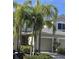 Tan two-story house with a two-car garage and lush landscaping at 558 Harbor Ridge Dr, Palm Harbor, FL 34683