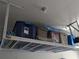 Overhead garage storage system with shelving unit, offering extra storage space at 558 Harbor Ridge Dr, Palm Harbor, FL 34683
