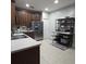 Well-equipped kitchen featuring stainless steel appliances and dark wood cabinets at 558 Harbor Ridge Dr, Palm Harbor, FL 34683