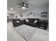 Spacious living room with gray couches and decorative wall art at 558 Harbor Ridge Dr, Palm Harbor, FL 34683