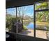 Enjoy the view from this screened porch with lake access at 558 Harbor Ridge Dr, Palm Harbor, FL 34683