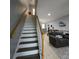 Modern staircase leading to the second floor, with a view of the living area at 558 Harbor Ridge Dr, Palm Harbor, FL 34683