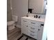 Modern bathroom with white vanity and walk-in shower at 5660 80Th N St # C307, St Petersburg, FL 33709