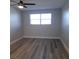 Bright bedroom with ceiling fan and laminate flooring at 5660 80Th N St # C307, St Petersburg, FL 33709