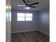 Well-lit bedroom, featuring wood-look floors and ceiling fan at 5660 80Th N St # C307, St Petersburg, FL 33709