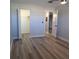 Bright bedroom with wood-look floors and access to bathroom at 5660 80Th N St # C307, St Petersburg, FL 33709