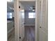 Open door view of bedroom with wood-look floors and large window at 5660 80Th N St # C307, St Petersburg, FL 33709
