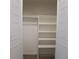 White closet with shelves and hanging rod at 5660 80Th N St # C307, St Petersburg, FL 33709