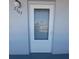 Unit entrance with storm door at 5660 80Th N St # C307, St Petersburg, FL 33709