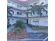 Building entrance with walkway and tropical landscaping at 5660 80Th N St # C307, St Petersburg, FL 33709