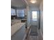 Open concept kitchen with white cabinets and large island at 5660 80Th N St # C307, St Petersburg, FL 33709