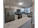 Modern kitchen with white cabinets, quartz countertops and stainless steel appliances at 5660 80Th N St # C307, St Petersburg, FL 33709
