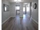 Spacious living room with wood-look floors and lots of natural light at 5660 80Th N St # C307, St Petersburg, FL 33709