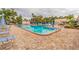 Community pool with lounge chairs and patio area at 5660 80Th N St # C307, St Petersburg, FL 33709