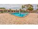Community pool with surrounding lounge chairs at 5660 80Th N St # C307, St Petersburg, FL 33709