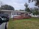 House exterior with a ramp and yard at 5902 18Th St, Zephyrhills, FL 33542