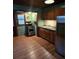 Small kitchen with wood cabinets at 5902 18Th St, Zephyrhills, FL 33542