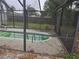 Green swimming pool with a screened enclosure at 5902 18Th St, Zephyrhills, FL 33542