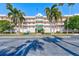 Two-story building exterior with palm trees and ample parking at 6315 Shoreline Dr # 3202, St Petersburg, FL 33708