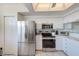 Modern kitchen with stainless steel appliances and white cabinets at 6315 Shoreline Dr # 3202, St Petersburg, FL 33708