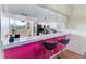 Kitchen features a breakfast bar and pink accent wall at 6315 Shoreline Dr # 3202, St Petersburg, FL 33708