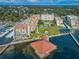 Aerial view of waterfront condo building with pool, dock, and parking at 632 Edgewater Dr # 439, Dunedin, FL 34698