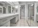 Bathroom with double vanity and large mirror at 632 Edgewater Dr # 439, Dunedin, FL 34698