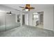 Spacious bedroom with mirrored closet and ceiling fan at 632 Edgewater Dr # 439, Dunedin, FL 34698