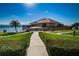 Waterfront clubhouse with a walkway and lush landscaping at 632 Edgewater Dr # 439, Dunedin, FL 34698