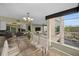 Bright dining area with a glass table and chairs, offering a view to the living room and outside at 632 Edgewater Dr # 439, Dunedin, FL 34698