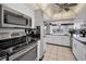 Modern kitchen with stainless steel appliances and white cabinets at 632 Edgewater Dr # 439, Dunedin, FL 34698