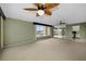 Spacious living room with large windows and neutral carpeting at 632 Edgewater Dr # 439, Dunedin, FL 34698