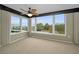 Bright living room with large windows and neutral carpeting at 632 Edgewater Dr # 439, Dunedin, FL 34698