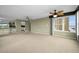 Spacious living room with large windows and neutral carpeting at 632 Edgewater Dr # 439, Dunedin, FL 34698