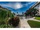 Landscaped walkway leading to a community pool with tropical foliage at 632 Edgewater Dr # 439, Dunedin, FL 34698