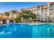 Inviting community swimming pool with ample lounge chairs and patio space at 632 Edgewater Dr # 439, Dunedin, FL 34698